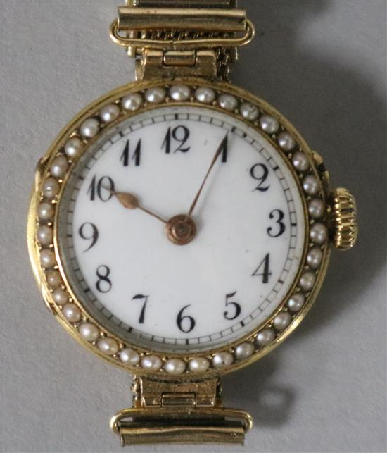 A ladys 18ct gold and split pearl set manual wind wrist watch, on a gold plated mesh bracelet.